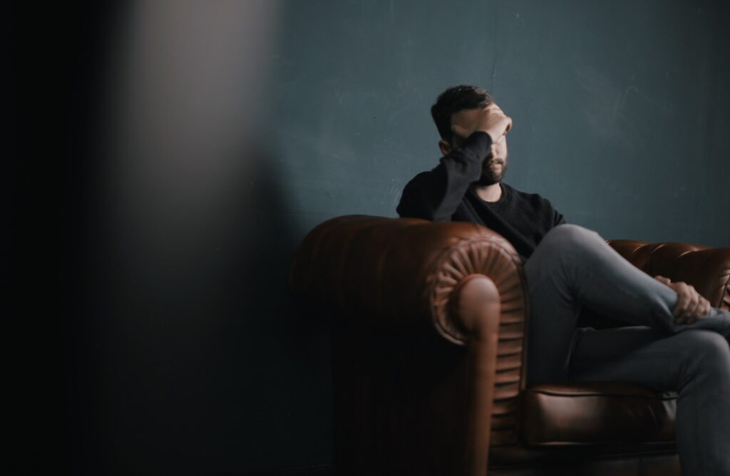 Man with brain fog holding head